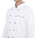 Model wearing a classic white full sleeve chef coat with black buttons and piping, showcasing the durable design.