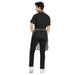 Back view of a man wearing a Premium Green Leather Apron with adjustable brass buckle, showcasing stylish design and durability.