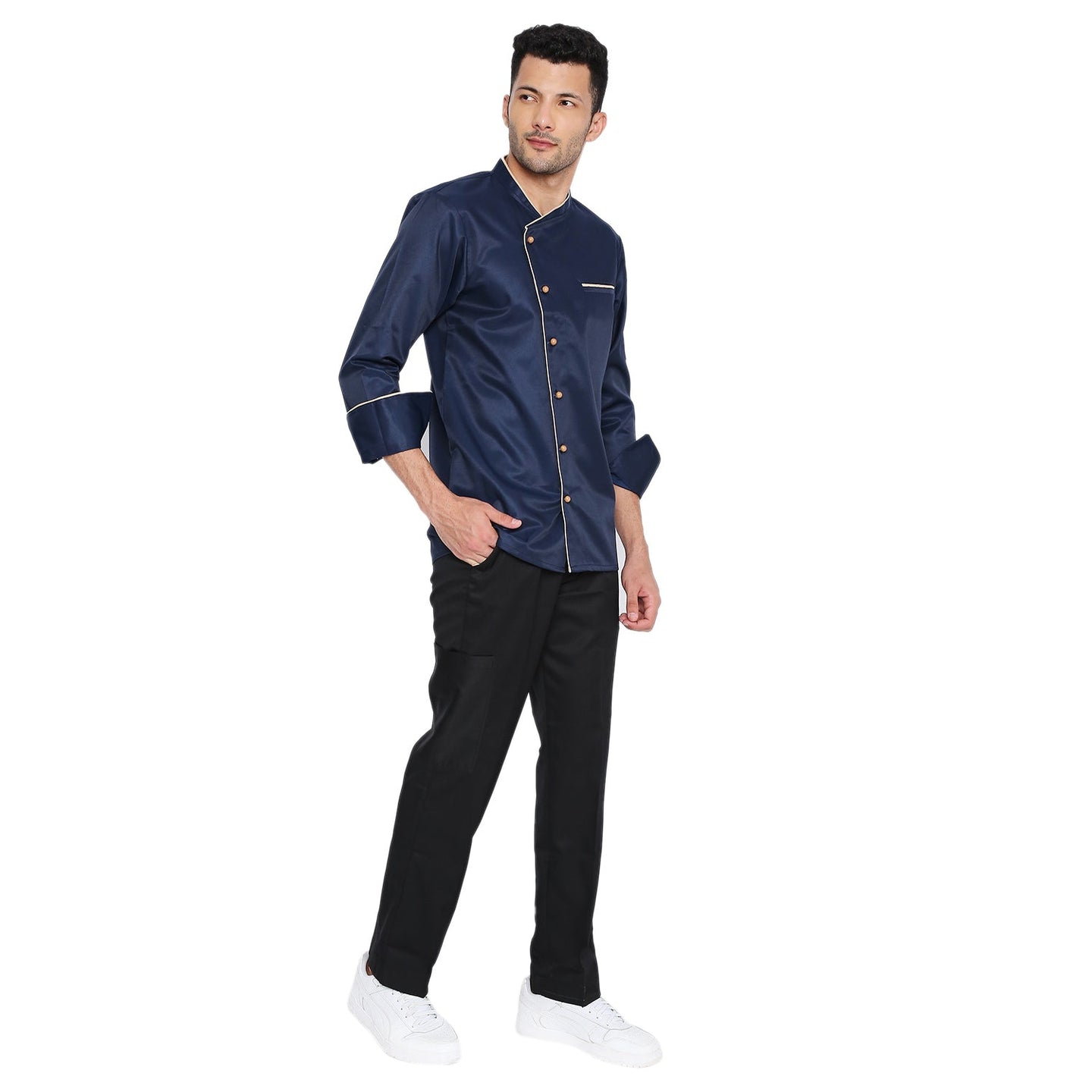 Navy blue full sleeve chef coat with cream piping, French cuffs, and buttons, worn by a model paired with black pants.