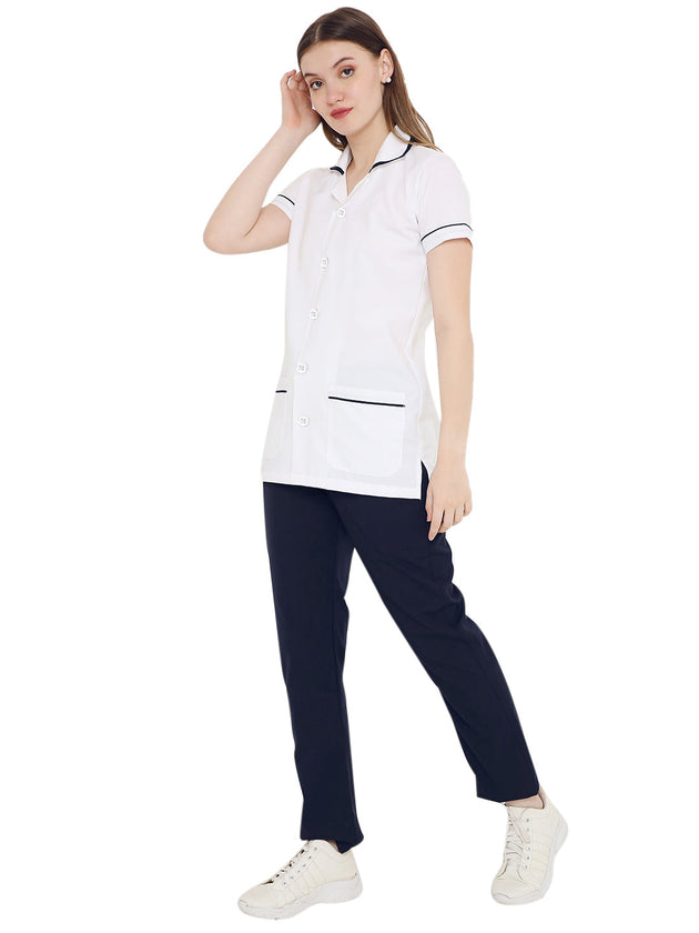 Women's nurse coat and pant set in white and navy, featuring half sleeves and pockets, made from premium polycotton.