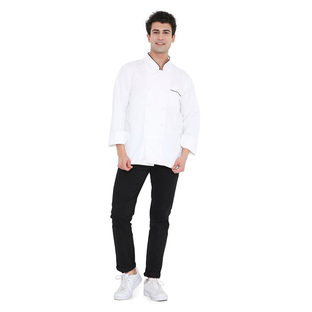 Male chef wearing a classic full sleeve white chef coat with black accents and pants, showcasing style and functionality.