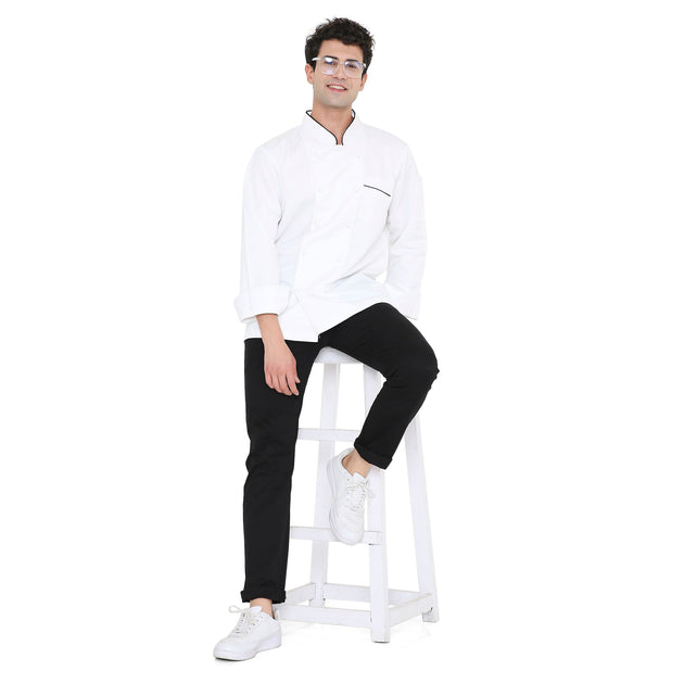 Model wearing a Classic Full Sleeve Chef Coat in white with black details, showcasing a stylish and professional kitchen look.