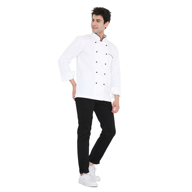 Model wearing a Classic Full Sleeve Chef Coat in white with black pants, showcasing durability and style for culinary professionals.