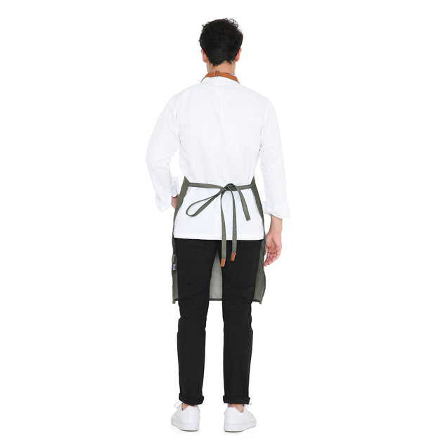 Man wearing a green premium leather apron from the back, showcasing adjustable neck strap and long back tie.