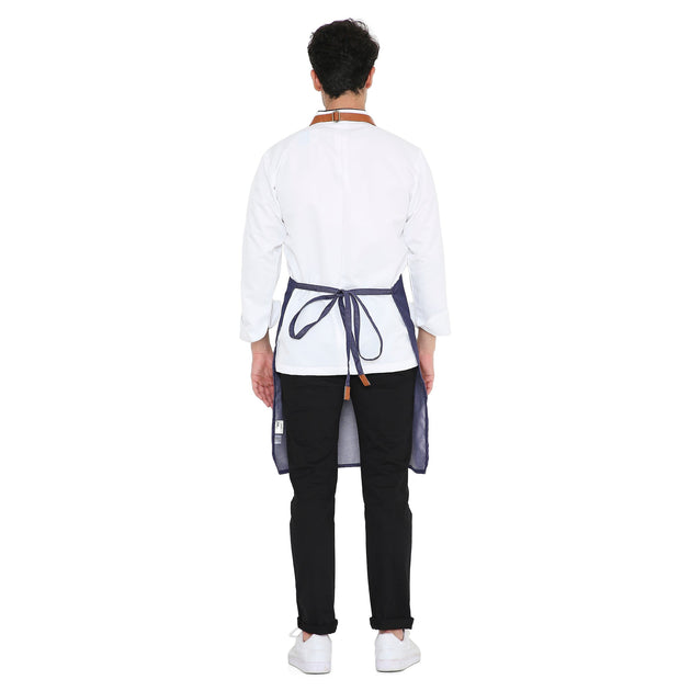 Back view of a man wearing a stylish Premium Leather Apron (Blue) with long ties, ideal for kitchen and bar use.