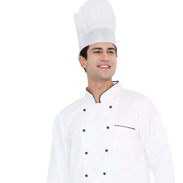 Male chef wearing a white non-woven disposable chef cap, smiling, in stylish kitchen attire.