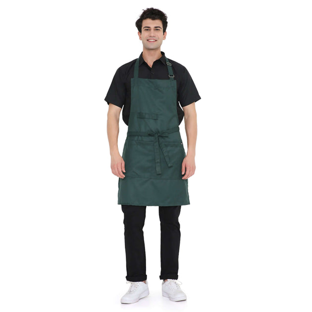 Dark green heavy quality kitchen apron on a smiling man, featuring adjustable neck loops and large storage pocket.