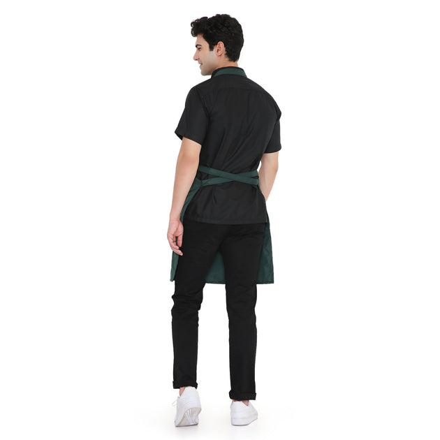 Man wearing a dark green classic kitchen apron, showcasing adjustable back ties and a stylish design.