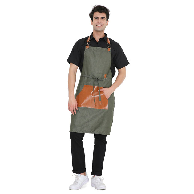 Man wearing a premium green leatherette apron with a large brown pocket, perfect for kitchen and bar use.