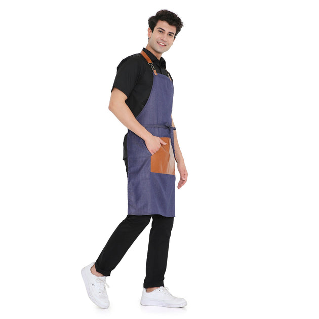 Stylish man wearing a blue premium leather apron with a large pocket, suitable for kitchen use, showing adjustable brass buckle.