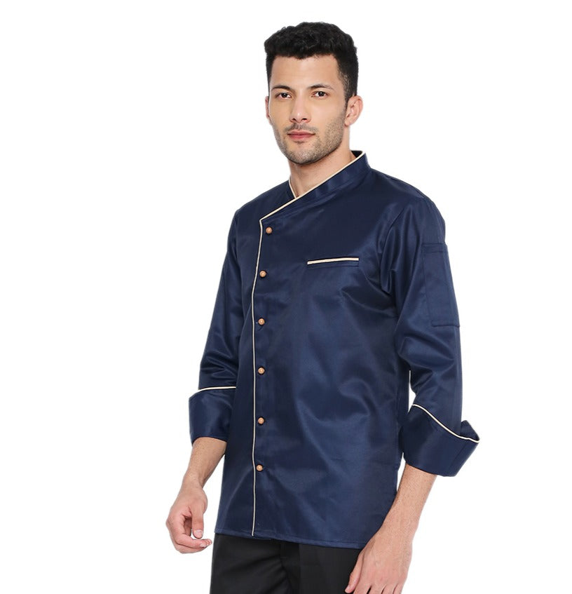 Navy blue chef coat with cream piping featuring French cuffs and mushroom buttons, perfect for culinary professionals.