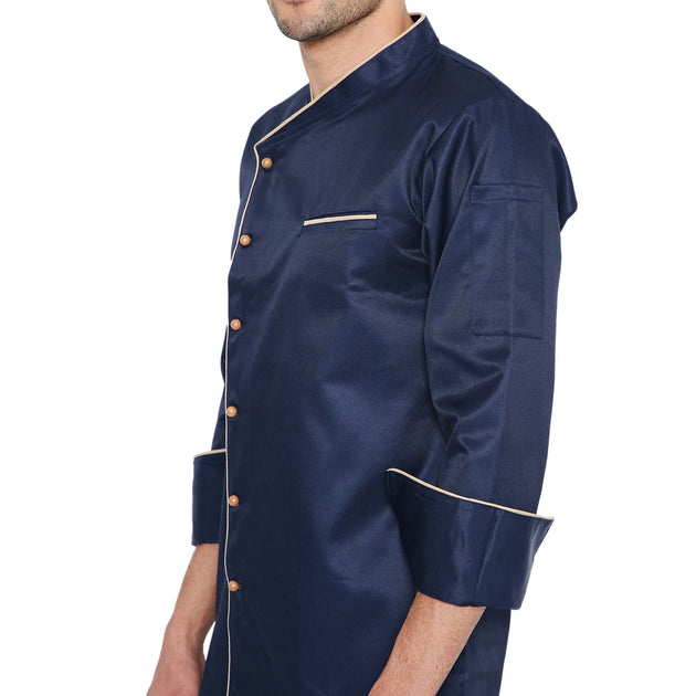 Navy blue full sleeve chef coat with cream piping and buttons, featuring a left-hand knife pocket and classic design.