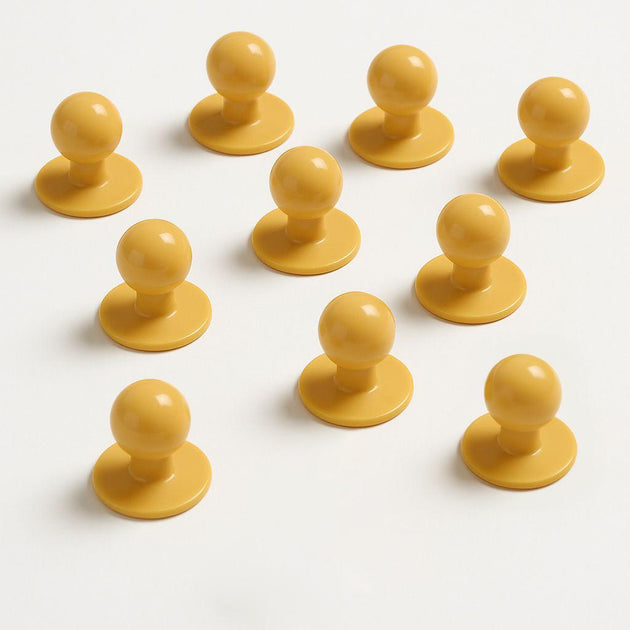 Set of ten yellow mushroom buttons designed for chef coats, customizable and quick to remove for kitchen emergencies.