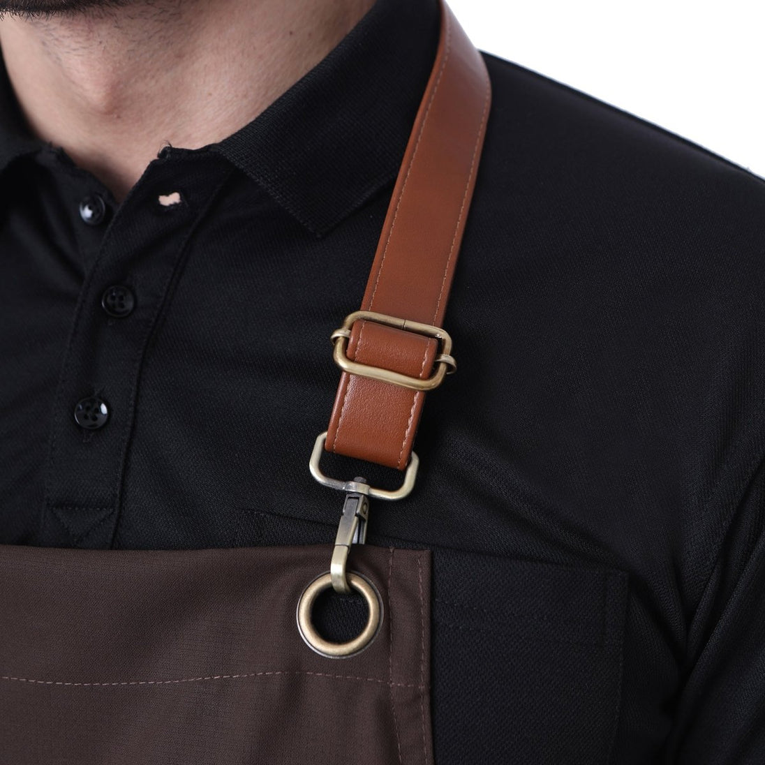 Leather neck strap buckle on coffee brown apron — adjustable fit