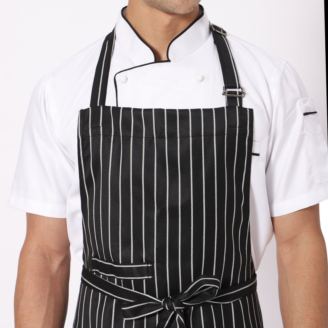 Black white broad line apron flat lay — adjustable neck strap and waist tie