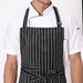 Black white broad line apron flat lay — adjustable neck strap and waist tie