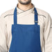 Royal blue bib apron flat lay — adjustable neck strap and waist tie