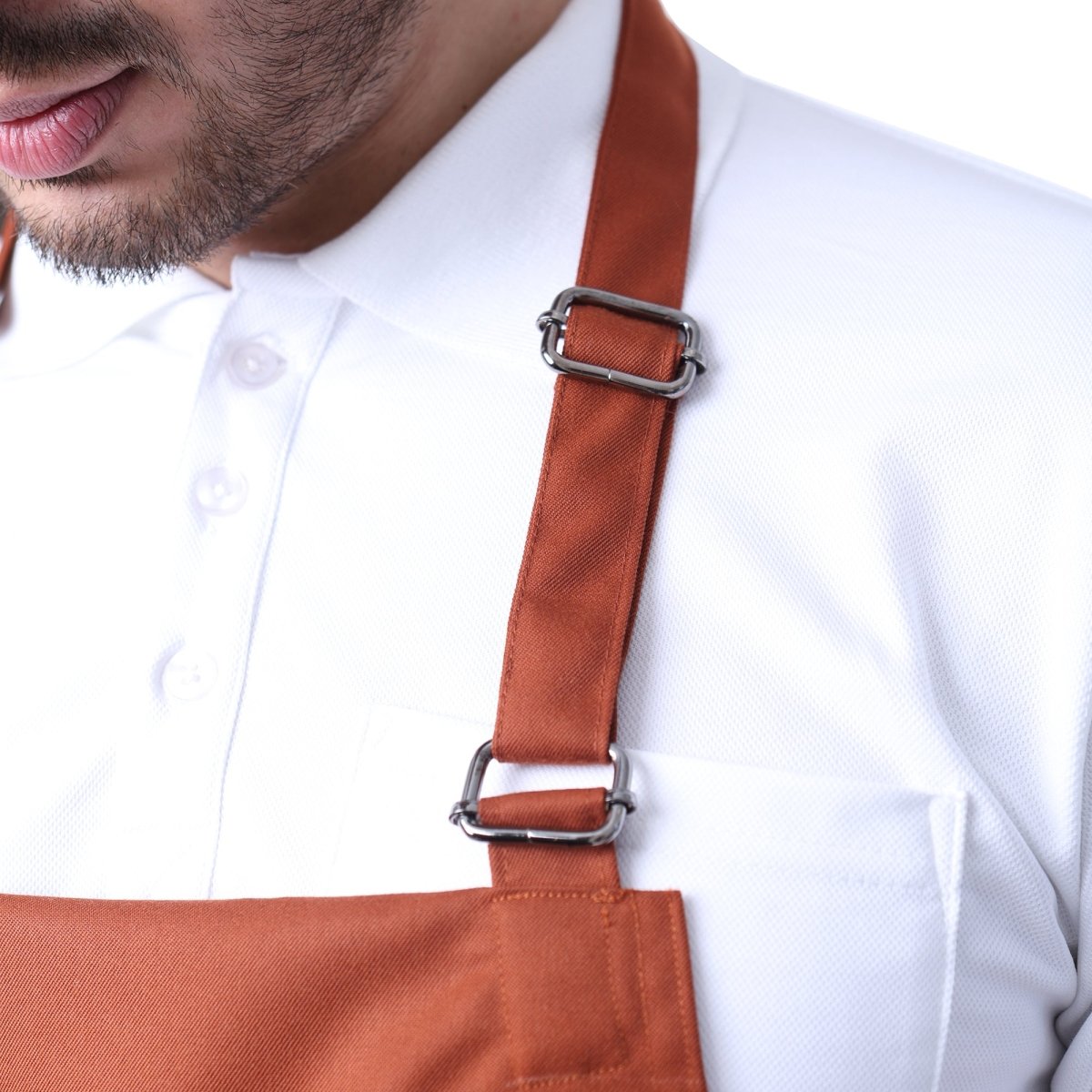 Rust orange apron front pocket detail — deep storage for kitchen tools