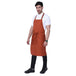 Rust orange bib apron flat lay — adjustable neck strap and waist tie