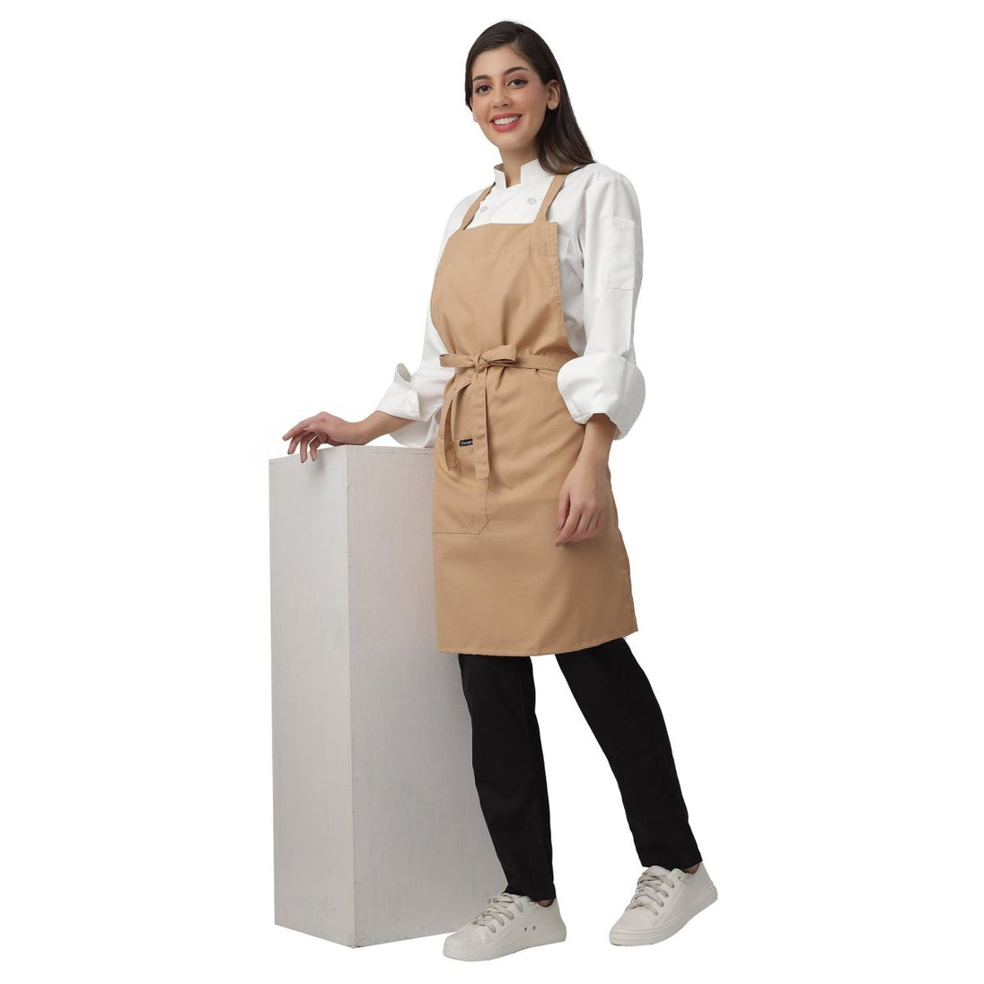 Set of 4 beige aprons laid out — bulk order free logo printing