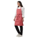 Set of 4 coral pink aprons laid out — bulk order free logo printing
