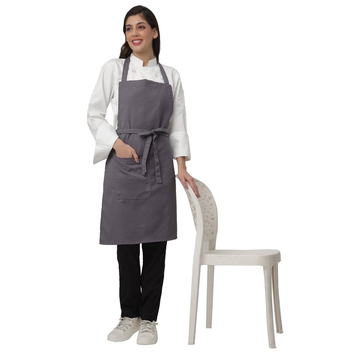 Pack of 4 grey aprons on model — hotel and cafe staff uniform