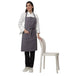 Pack of 4 grey aprons on model — hotel and cafe staff uniform