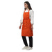 Pack of 4 orange aprons on model — hotel and cafe staff uniform