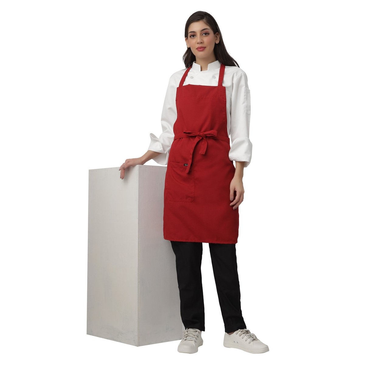 Red apron pocket detail — deep front pocket for kitchen staff