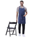 Classic blue denim kitchen apron front view — adjustable straps, front pocket
